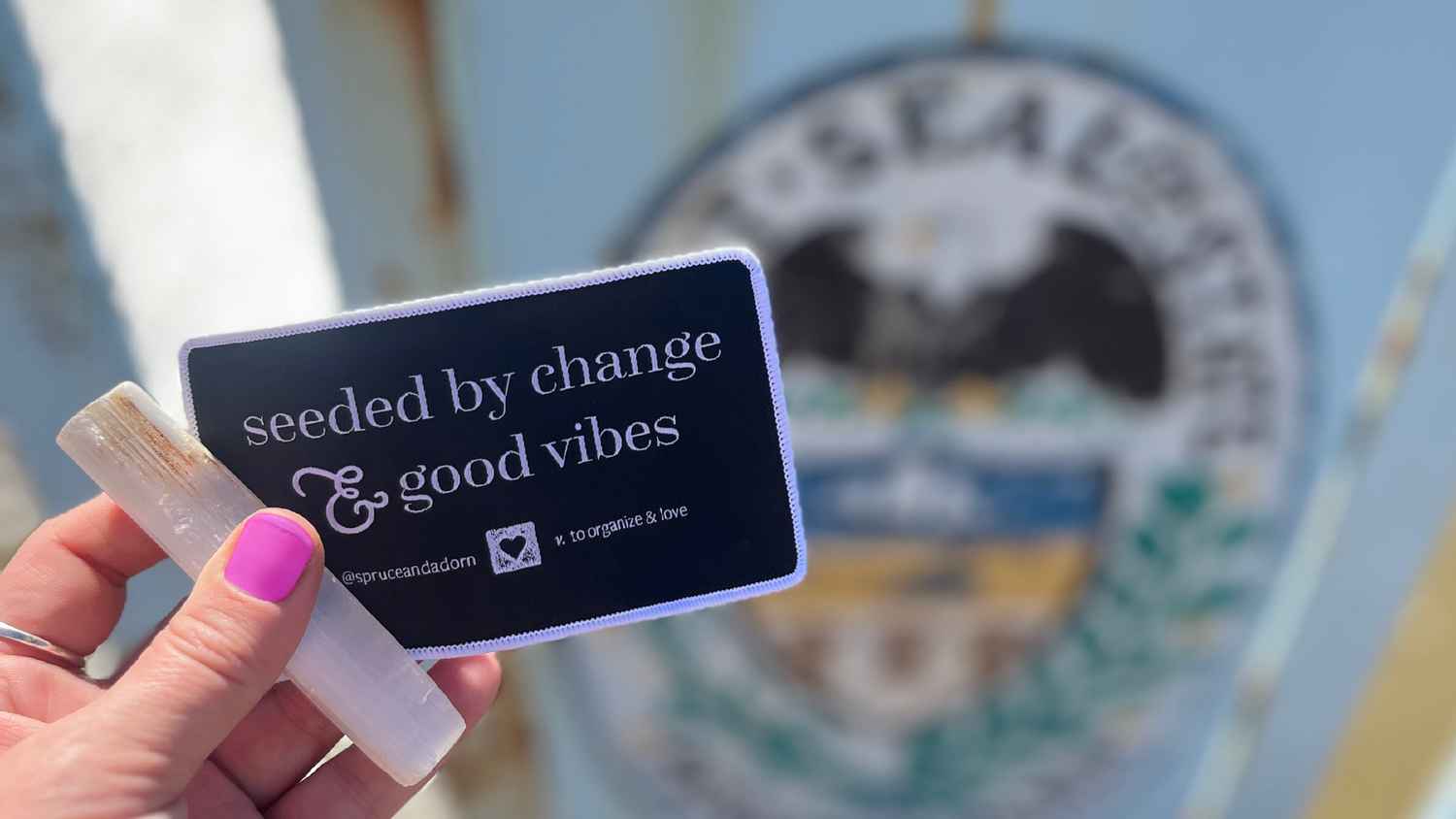 spruce & adorn™ introduces here newest patch to the positive affirmation apparel designed and printed in Pennsylvania. Seed by Change and Good Vibes seen with a stick of liquid selenite is positioned radiates sun energy over the Allegheny River 40th Street overpass in Lawrenceville, Pa. What's behind? The Pennsylvania State Seal.